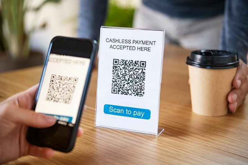 Customer-scanning-tag-in-coffe-398359028